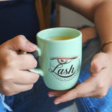 a woman holding a cup of tea in her hands