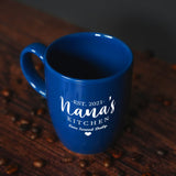 a blue coffee mug sitting on top of a wooden table