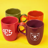 a group of four coffee mugs sitting next to each other