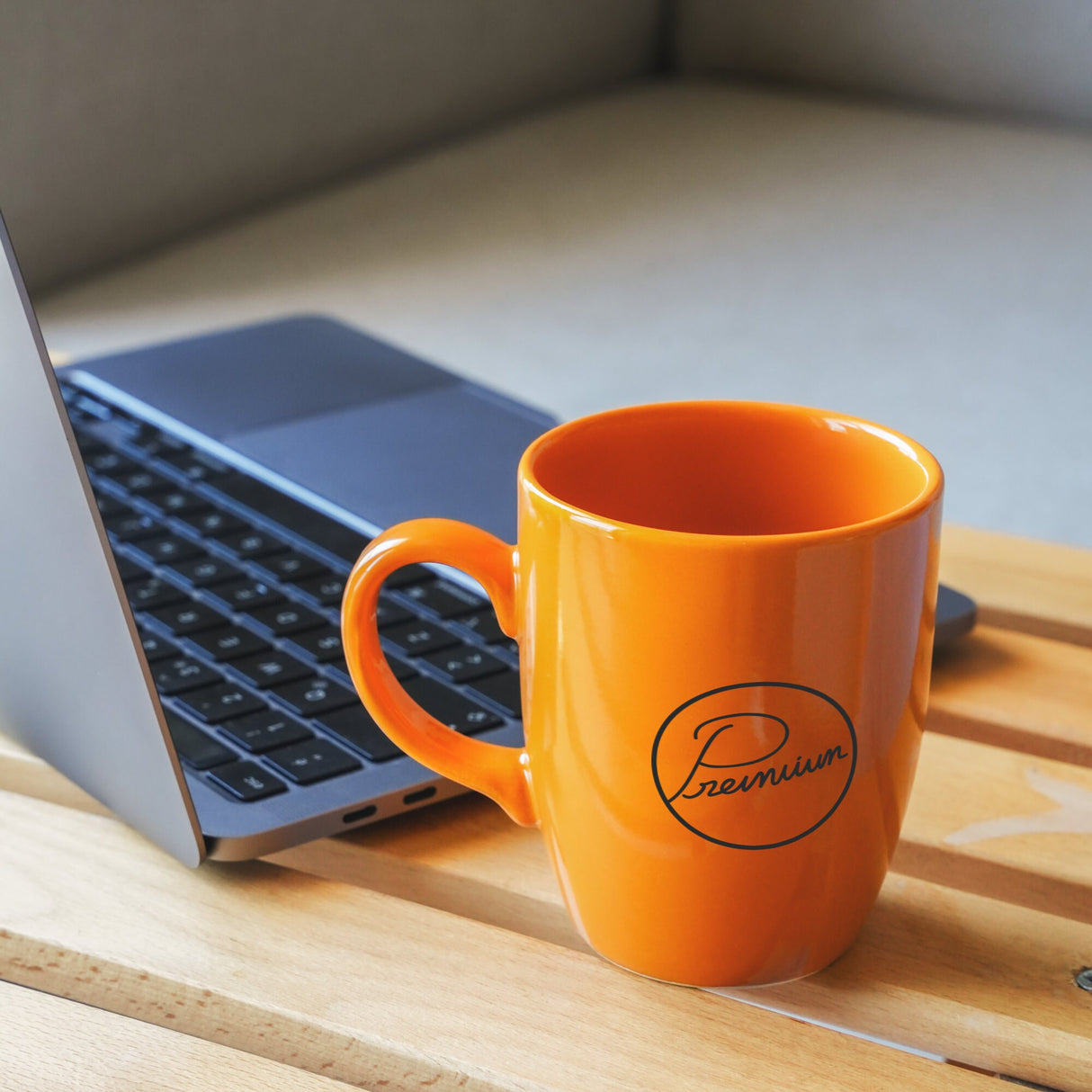 a coffee cup sitting next to a laptop computer