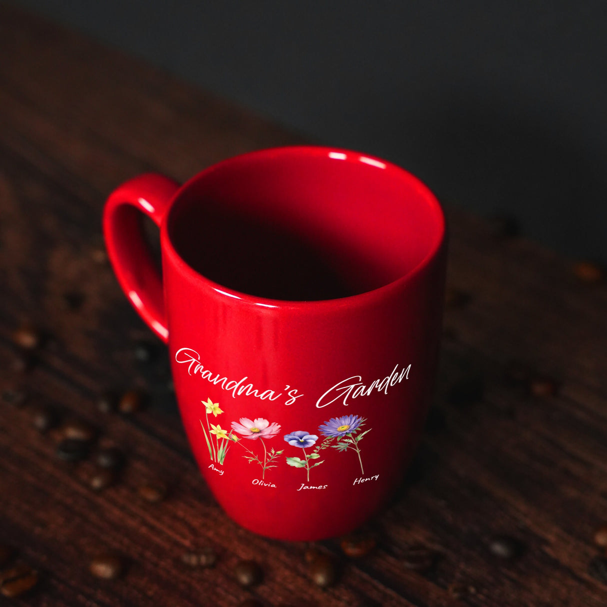 a red coffee mug sitting on top of a wooden table