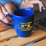 a person is holding a coffee mug in front of a laptop