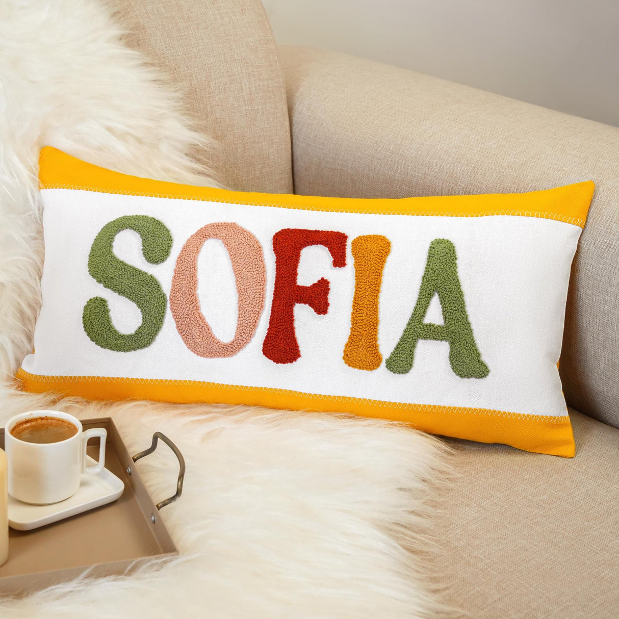 a sofa with a coffee cup and a pillow that says sofa