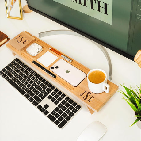 a desk with a keyboard and a cup of coffee