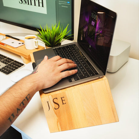 a person typing on a laptop on a desk