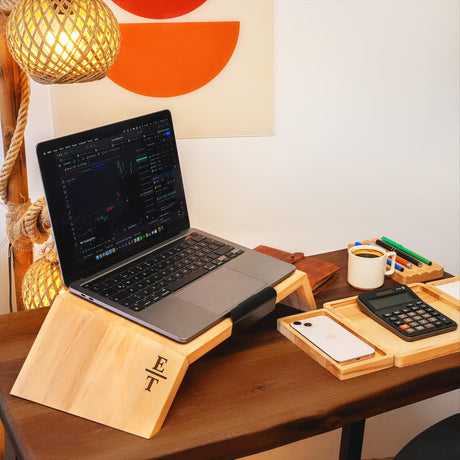 a laptop computer sitting on top of a wooden desk