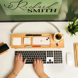 a person is typing on a keyboard on a desk