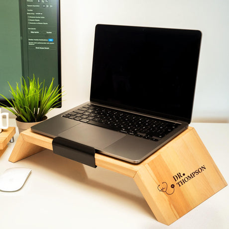 a laptop computer sitting on a wooden stand