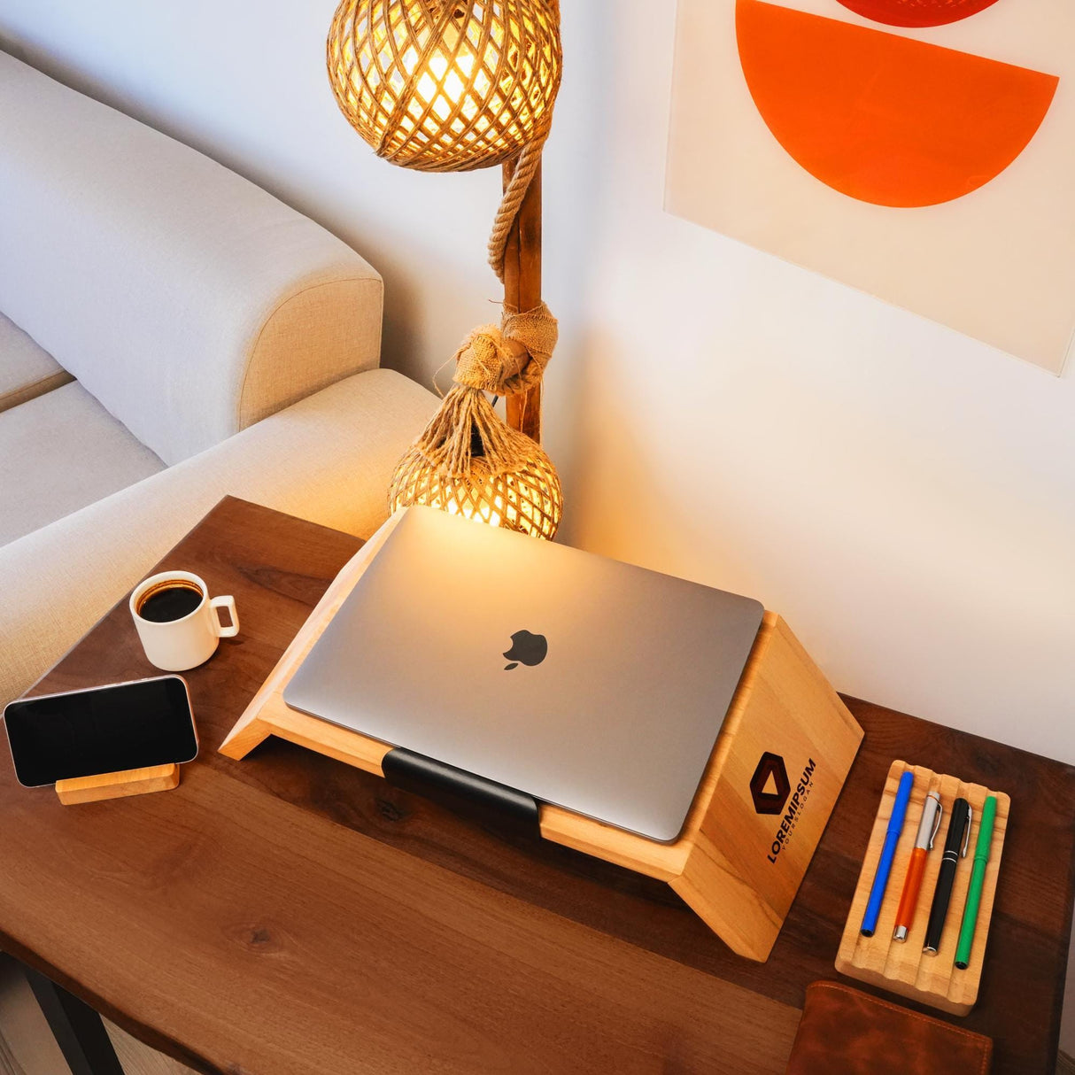 a wooden table with a laptop and a phone on it