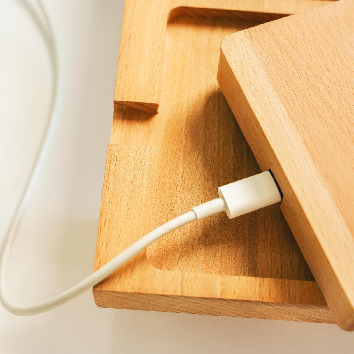 an electronic device plugged into a wooden box