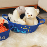 two stuffed animals in baskets on a white rug