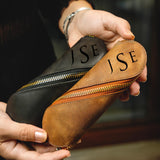 a person holding a wallet with the word ise written on it