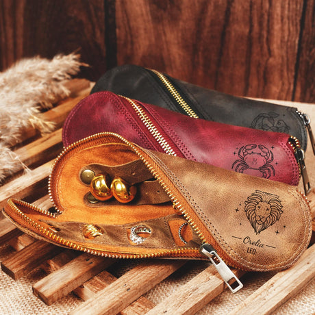 three leather purses sitting on top of a wooden tray