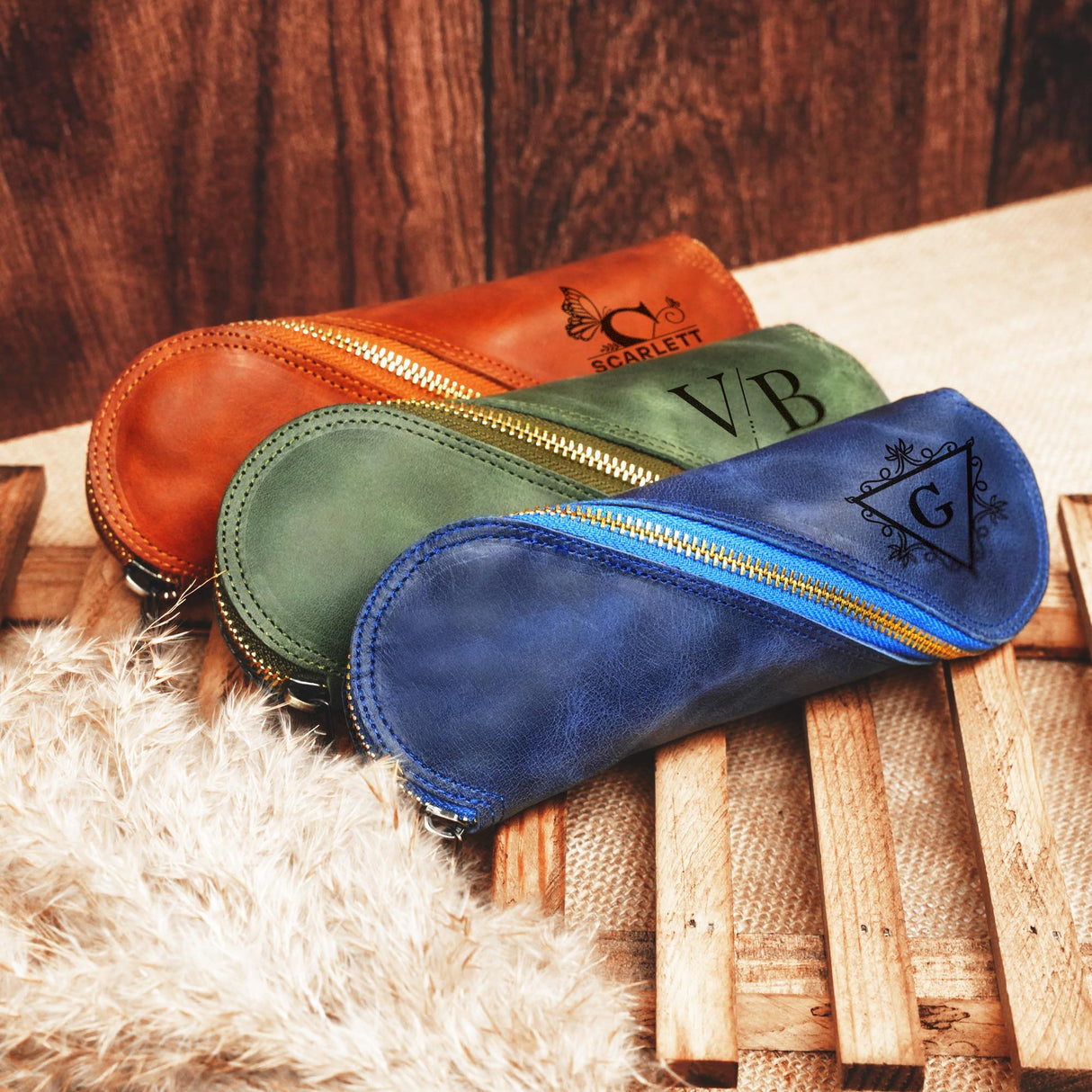 a group of three bags sitting on top of a wooden floor