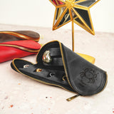 a pair of black shoes sitting next to a star shaped object