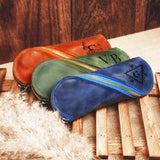 a group of three bags sitting on top of a wooden floor