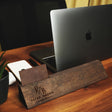 a wooden business card holder sitting on top of a wooden desk