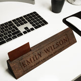 a wooden name plate sitting on top of a desk