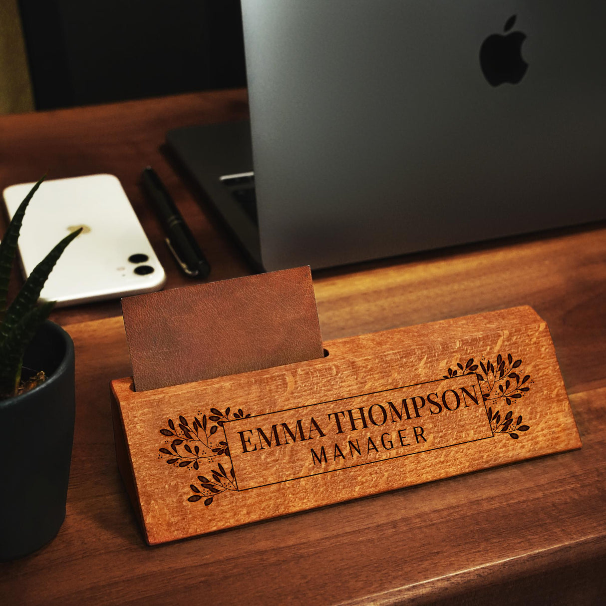 a wooden business card sitting on top of a desk