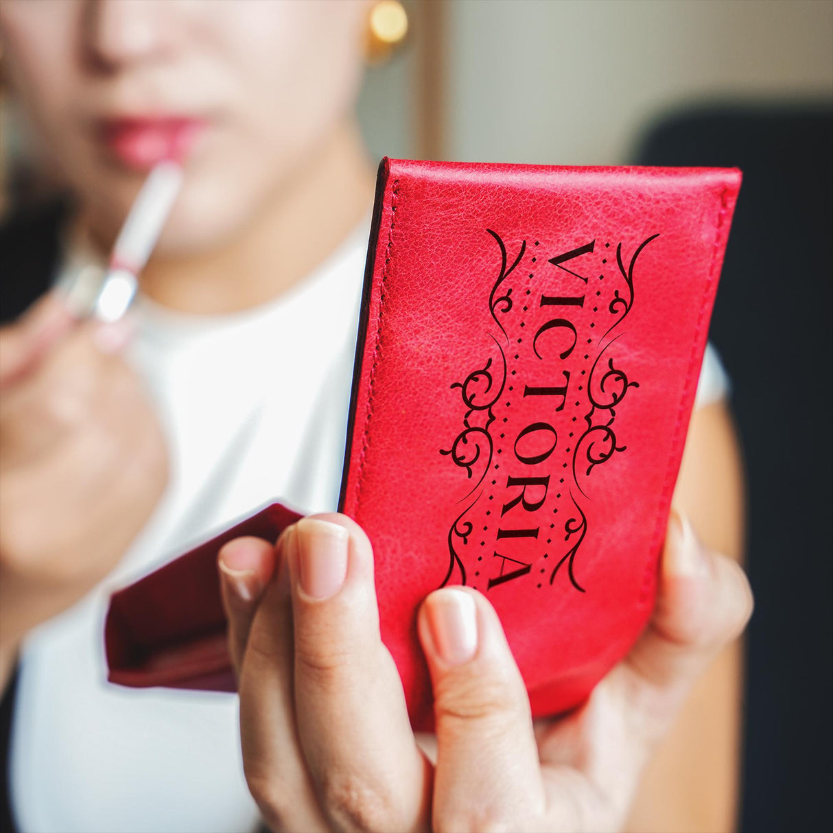 a woman holding a red book in her hands