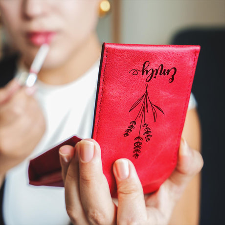 a woman holding a red book with writing on it