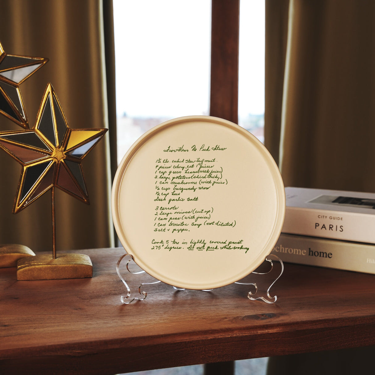 a plate with a poem written on it sitting on a table next to a book