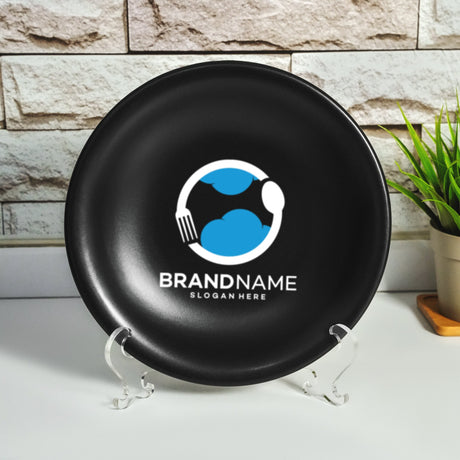 a black frisbee sitting on top of a table next to a potted