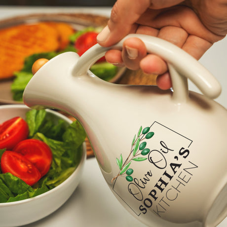 a person pouring a tea into a bowl of salad