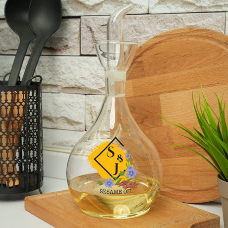 a bottle of sesame oil next to a potted plant