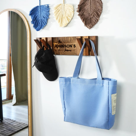 a blue bag hanging on a wall next to a mirror