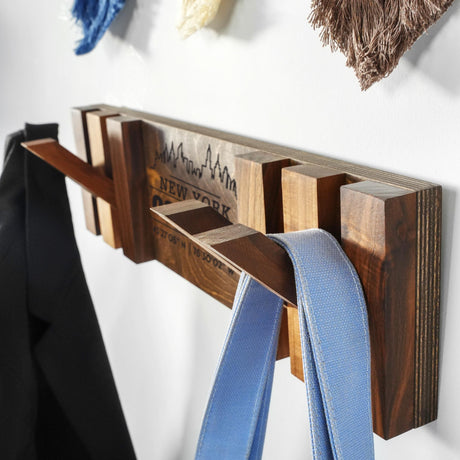 a coat rack with a blue ribbon hanging from it