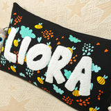 a black pillow with the word lora on it