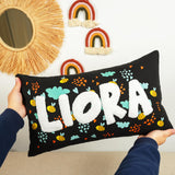 a person holding a pillow with the word lora on it