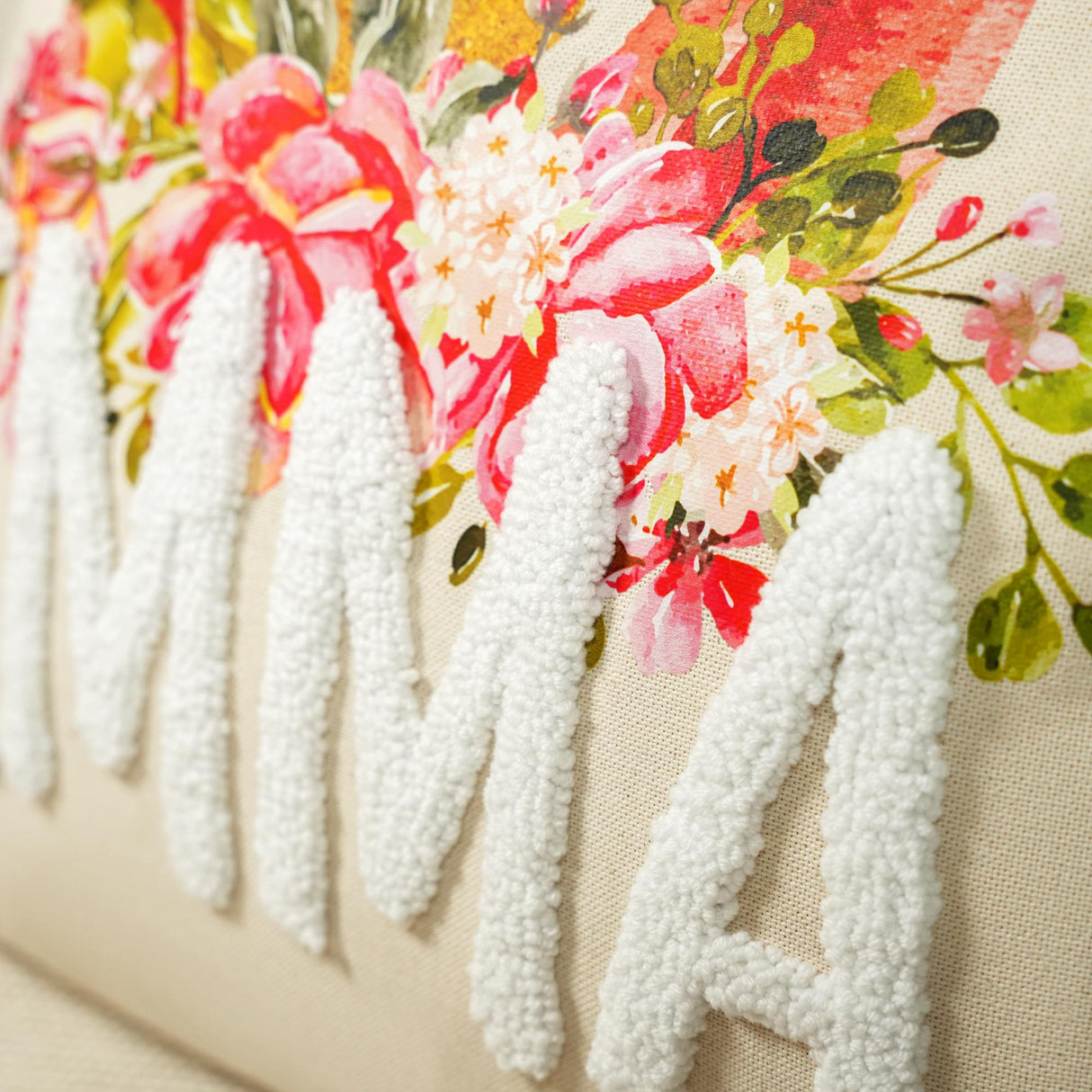 a close up of a pillow with flowers on it