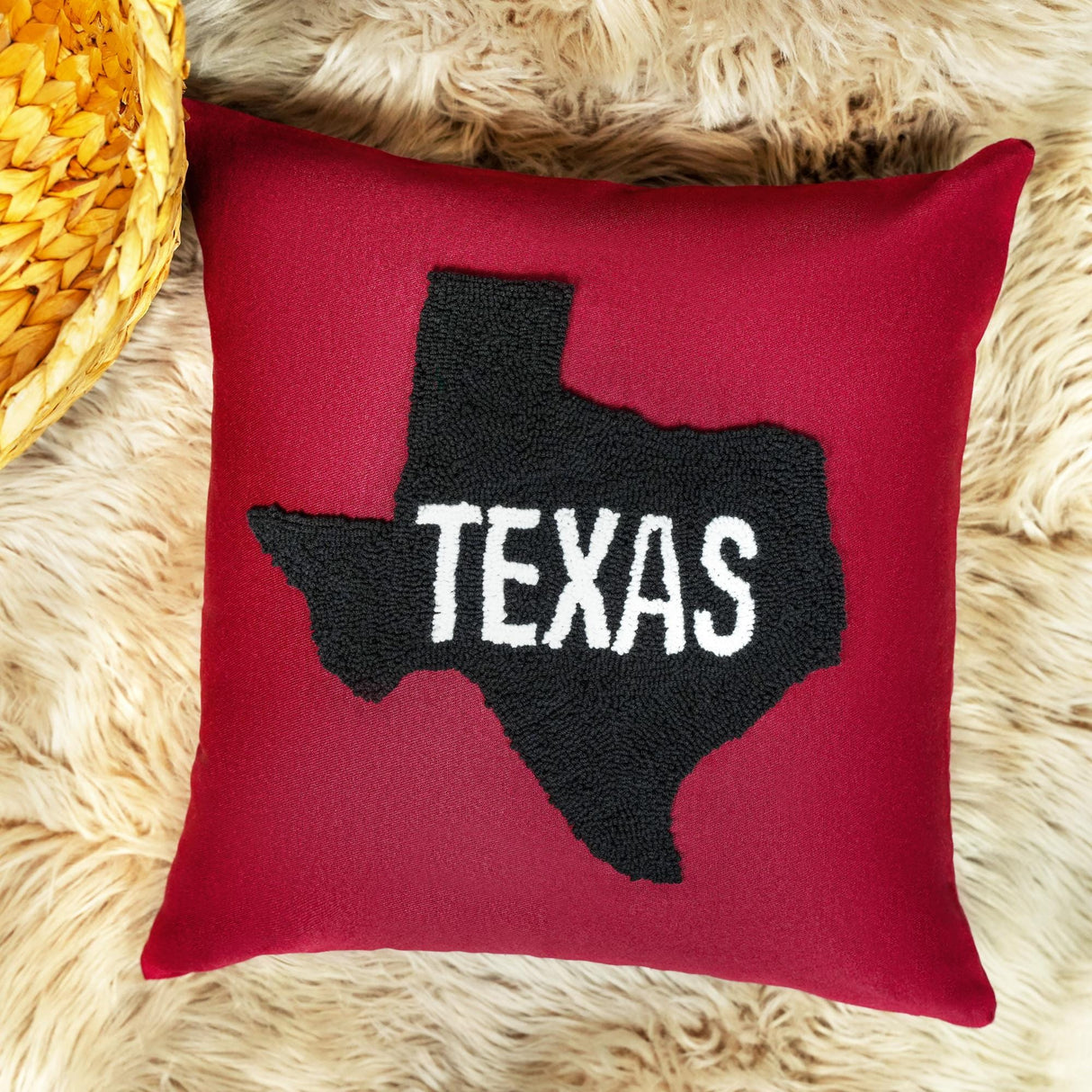 a red pillow with the word texas on it