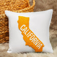 a white pillow with the state of california embroidered on it