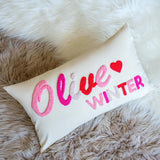 a white pillow with the words olive winter painted on it