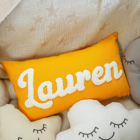 a yellow pillow with the word lauren on it