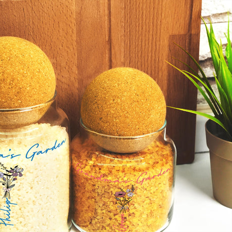 a couple of jars filled with food next to a potted plant