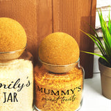 a couple of jars filled with food next to a potted plant