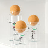 three glass jars with cork lids on a shelf