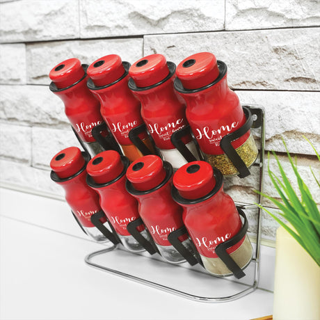 a stack of red bottles sitting on top of a counter