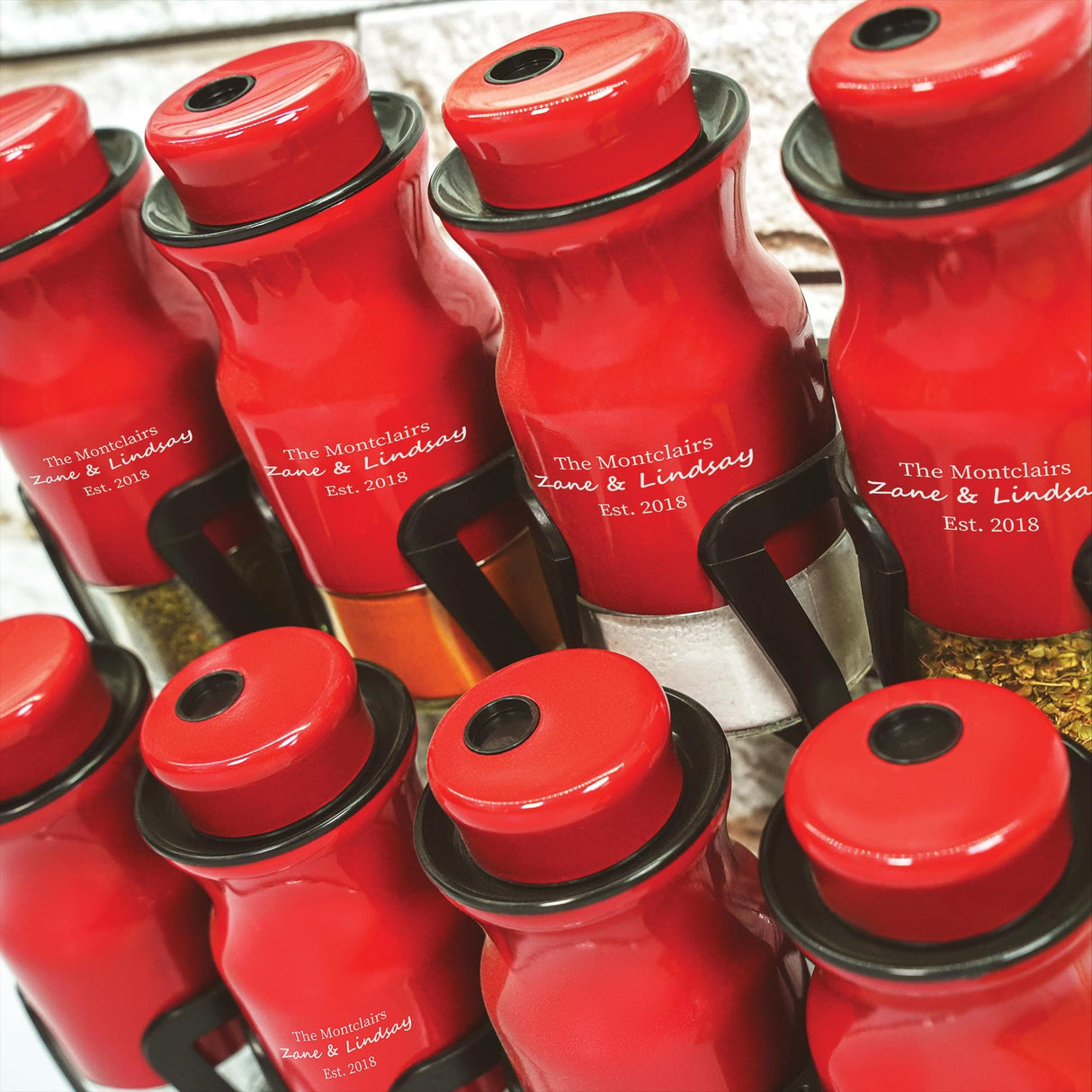 a bunch of red bottles sitting on top of a table