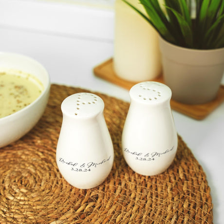 a couple of salt and pepper shakers sitting on top of a mat