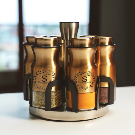 a set of four spice jars sitting on top of a counter