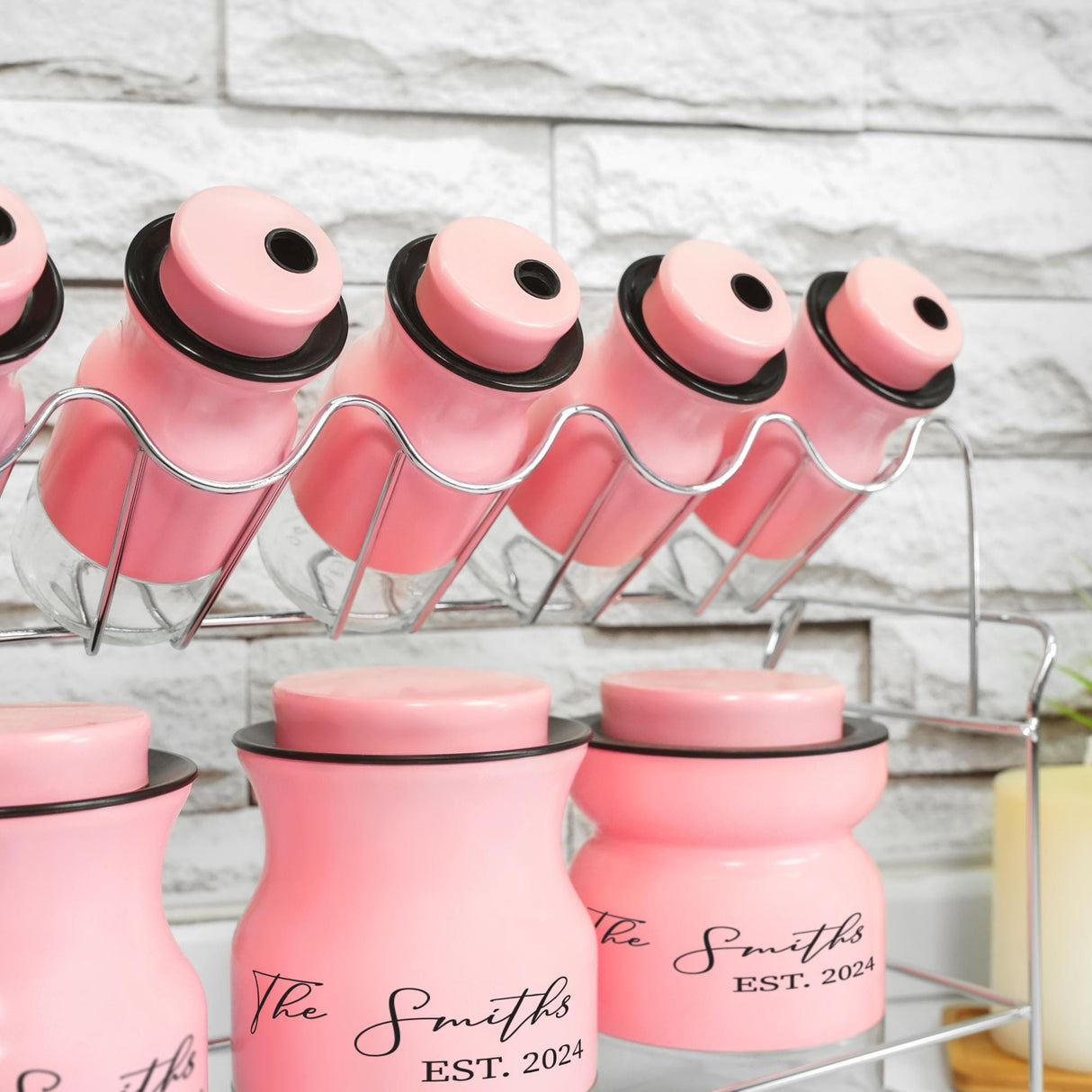 a rack of pink jars with black lids