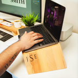 a person typing on a laptop on a desk