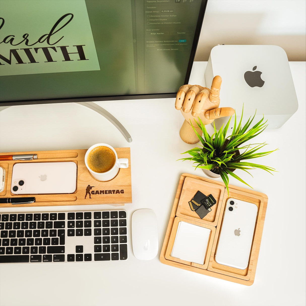 a desk with a computer, keyboard, mouse and plant