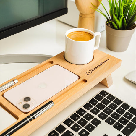 a cup of coffee sitting on top of a wooden tray next to a keyboard