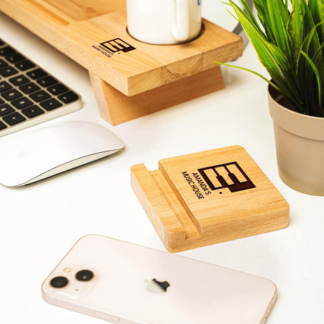 a wooden business card holder sitting on top of a desk